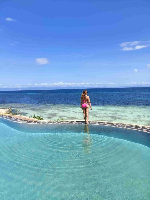 photo of me at Mithi beach resort in the Philippines for my blog post on 2 week Philippines itinerary