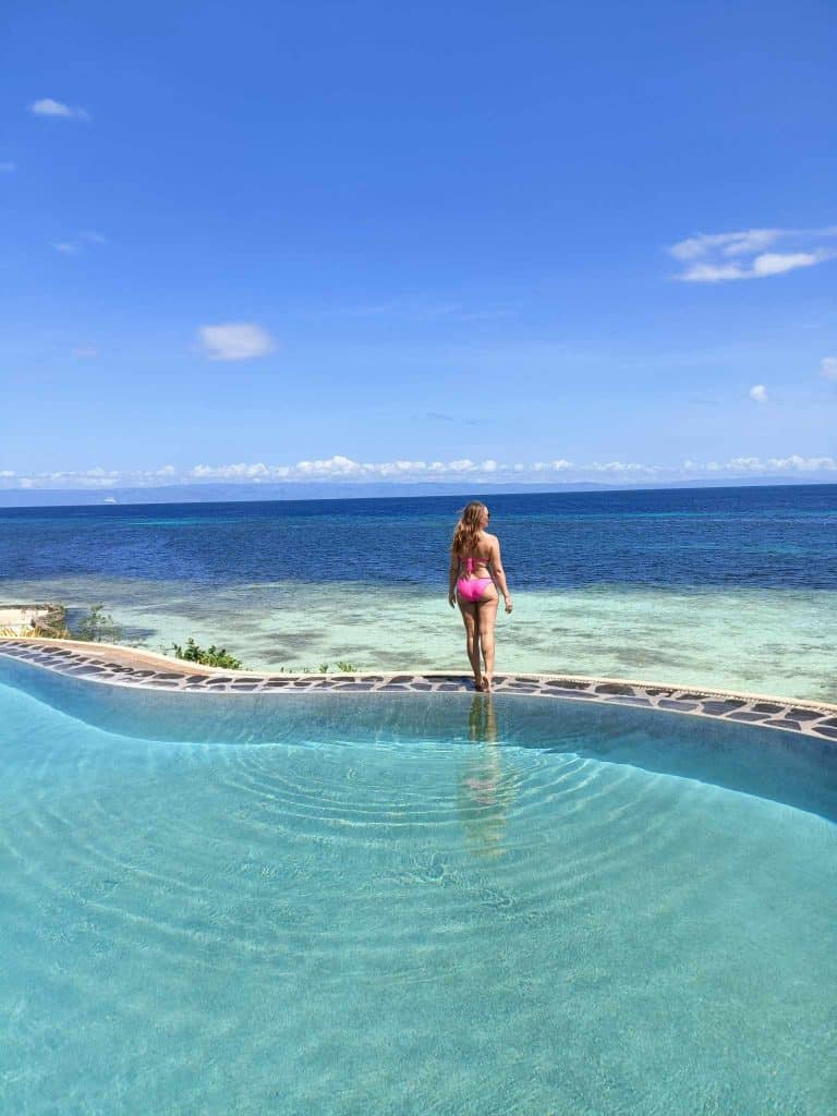 photo of me at Mithi beach resort in the Philippines for my blog post on 2 week Philippines itinerary