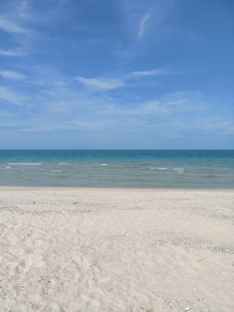 white sand beach and turquoise water with a blue sky on a Thailand beach