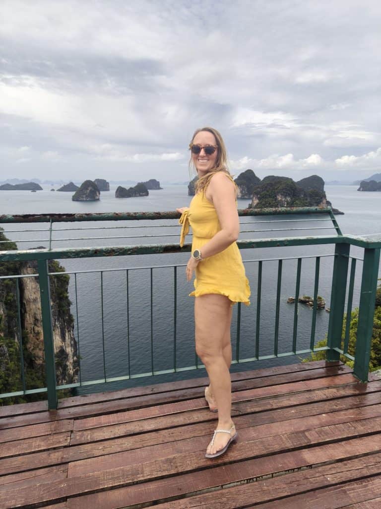 steffi, teacher and blogger wearing a yellow playsuit on top of a view point in Thailand