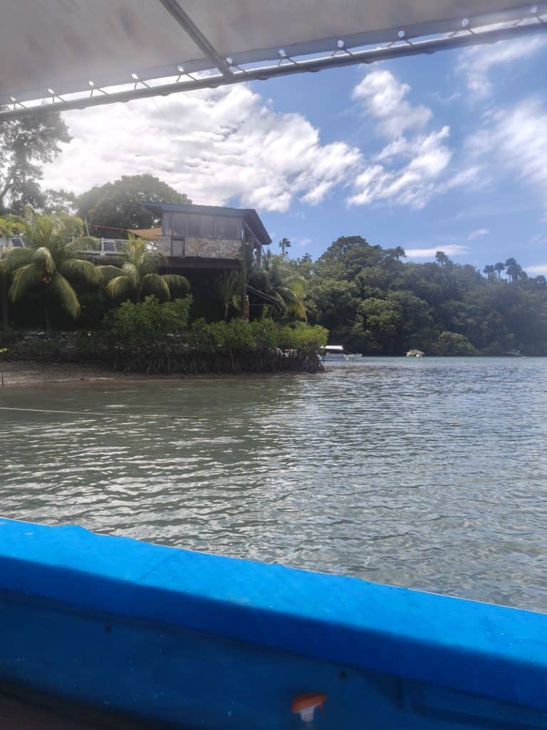mangrove bay from a blue boat and Edgewater dive resort behind